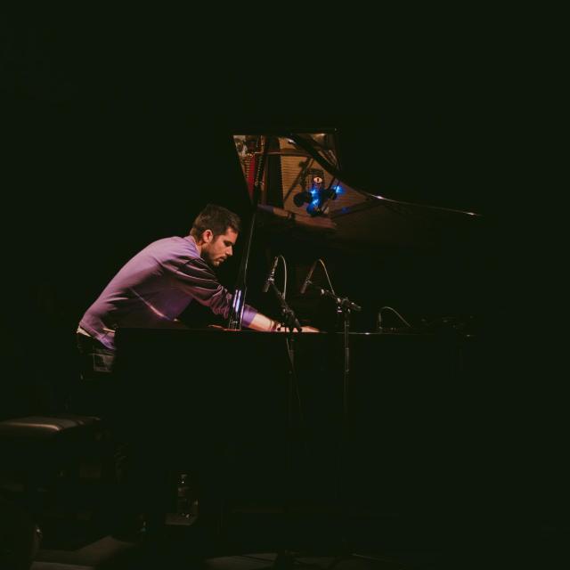Philipp playing the Piano with a mallet.