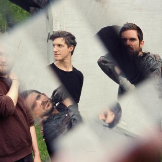 A peculiar photo of the trio divr; with the use of a prism in front of the lense, some of the faces appear twice in another place.